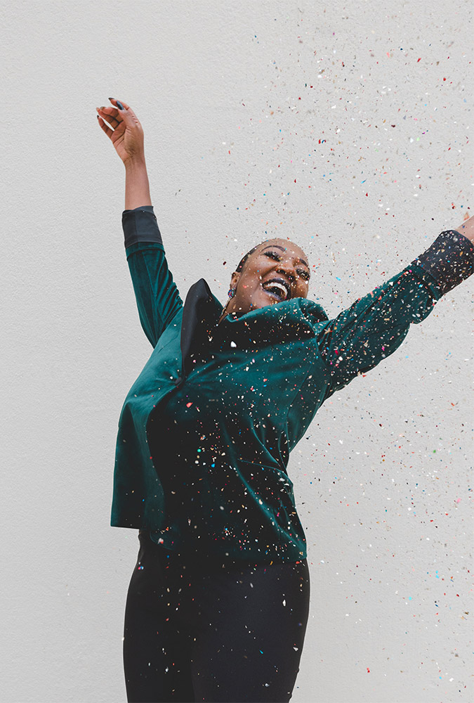 happy woman throwing confetti