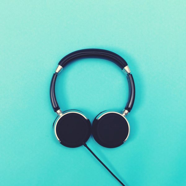 Pair of black headphones on a blue background