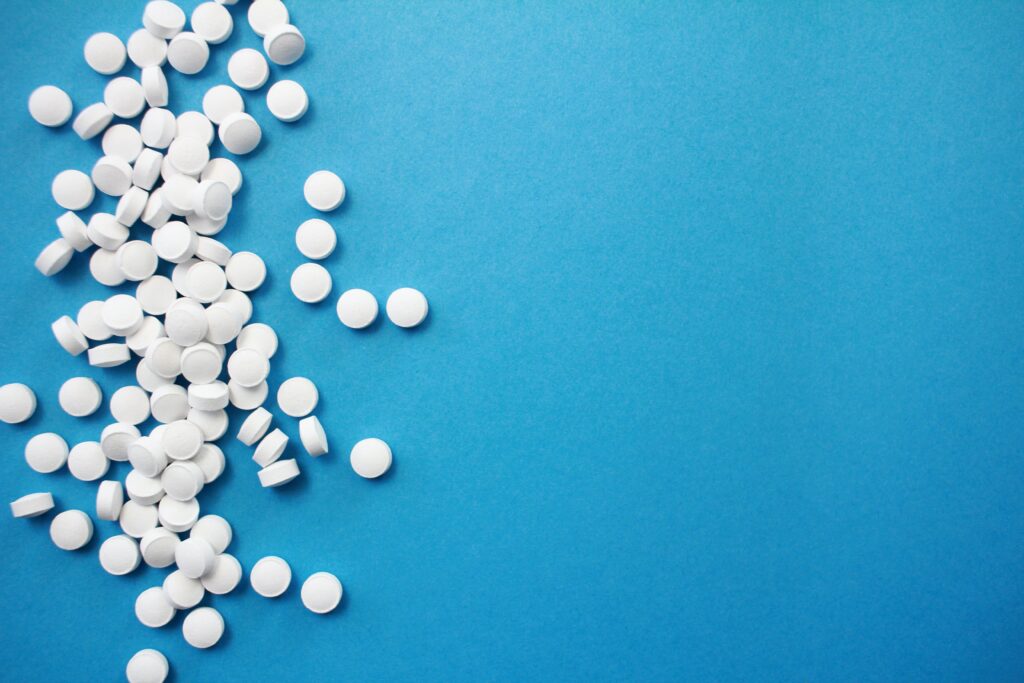 white pills against blue background