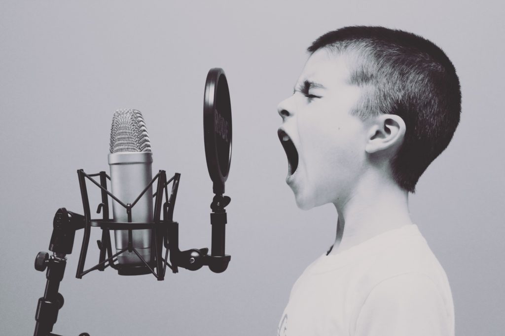 Boy yells into microphone demonstrating near range audio.