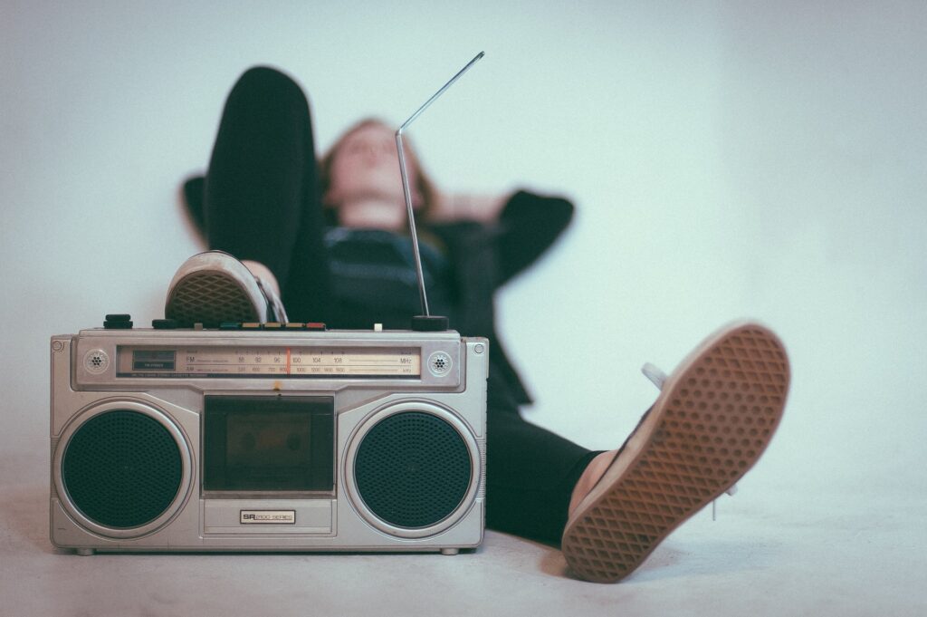 person lounging behind a boombox