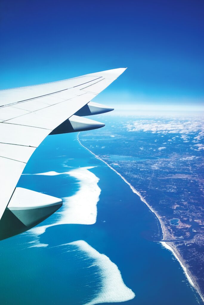 plane flying over body of water